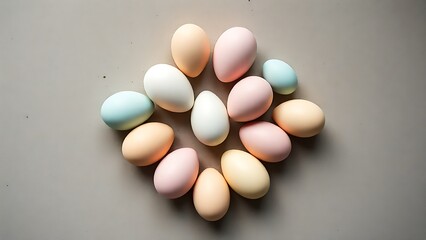 Pastel Easter eggs arranged in a geometric pattern on a concrete surface, bathed in soft morning light.