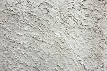 Textured white wall with unique patterns and surfaces in natural light