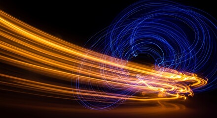 Dynamic light trails in orange and blue against black background