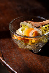 Rustic Glass Molcajete with Pickled Habanero Peppers and Wooden Spoon on Wooden Table