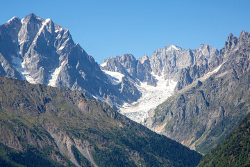 Fototapeta premium Majestic mountain range with glacier under clear blue sky during daytime