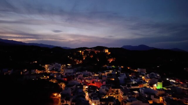 Night aerial drone view of Monda and its castle, Andalusia, Spain