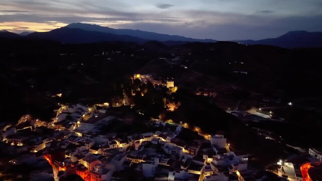 Night aerial drone view of Monda and its castle, Andalusia, Spain