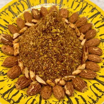 Aromatic spice blend with nuts and dried fruit on a decorative plate