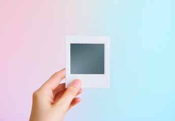 Hand Holding Blank Photo Frame Pastel Background