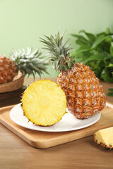 Fresh Golden Pineapple Cut in Half Showing Sweet Yellow Meat on Wooden Board