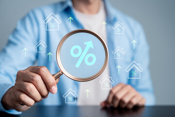 Property value increase and real estate investment growth concept. Magnifying glass with percentage, mortgage interest rates, finance, and housing economy.