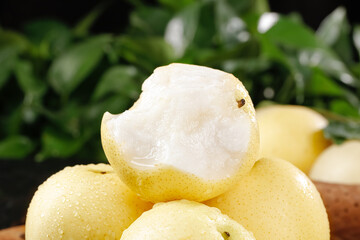 Fresh White Pear Slices with Crown Shape on Wooden Board Against Green Natural Background