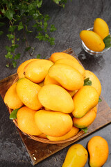 Fresh Xiaotainong Mangoes from Hainan China in Rustic Basket - Tropical Fruit Harvest Display