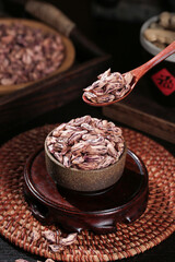 Dried Grain Seeds in Rustic Wooden Bowl with Traditional Spoon