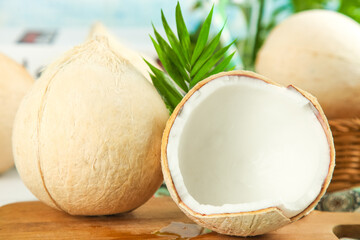 Fresh Hainan Coconuts with White Meat and Water on Wooden Table - Tropical Fruit Health Food Concept