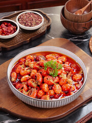 Spicy Qianjiang Style Crawfish with Red Chili Sauce and Fresh Herbs on Wooden Serving Board