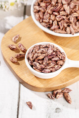 Colorful Pinto Beans in Bowls on Wooden Board - Healthy Legumes and Grains