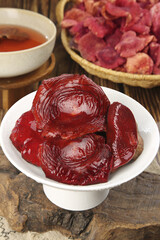 Red Dried Fujian Mushrooms on White Plate with Tea - Traditional Chinese Cooking Ingredients