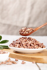 Striped Sunflower Seeds in Bowl with Wooden Spoon - Healthy Natural Snack Food