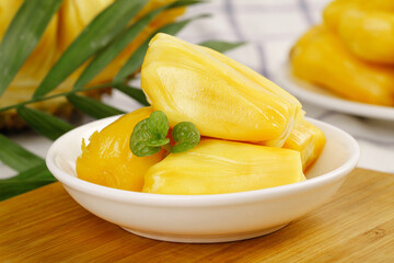 Fresh Vietnamese Red Pineapple Slices with Mint Garnish in White Bowl