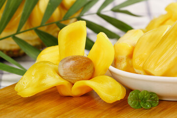 Fresh Vietnamese Honey Pineapple Slices with Tropical Leaves on Wooden Background