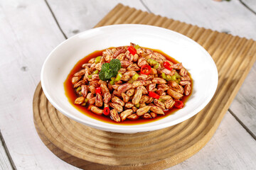 Spiced Peanut Dish with Colorful Peppers and Herbs in Savory Sauce on Wooden Background