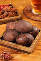 Obraz premium Five Spice Roasted Duck Eggs with Traditional Chinese Spices on Wooden Tray