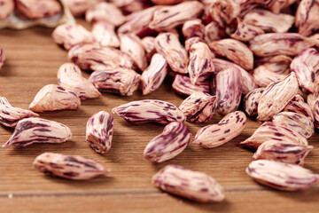 Colorful Speckled Heirloom Beans on Wooden Background - Natural Legumes and Kernels for Healthy Cooking