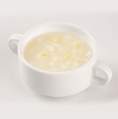 Fresh corn soup with kernels in white bowl - healthy homemade meal with natural ingredients and corn germ