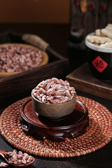 Traditional Homegrown Colorful Rice in Ceramic Bowl with Small Peanuts and Grains on Woven Mat