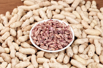 Colorful Striped Peanut Kernels in Bowl with Raw Peanuts Shell Background - Homegrown Farmers...