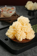 Fresh Silver Fungus White Jelly Mushrooms Traditional Asian Cooking Ingredient on Wooden Serving Plate