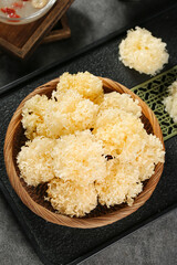 Dried White Silver Ear Mushrooms in Bamboo Bowl - Traditional Chinese Glutinous Fungus Ingredient