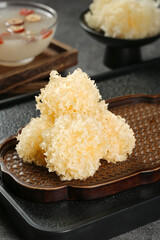 White Snow Fungus Tremella Dried Chinese Medicine Ingredient on Wooden Plate