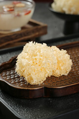 White Silver Ear Mushroom Snow Fungus on Wooden Tray Traditional Asian Cooking Ingredient