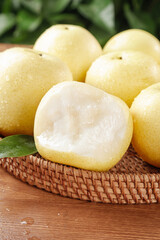 Fresh White Crown Pears from Hebei China in Wicker Basket on Wood Table