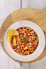 Colorful Spiced Peanut Bean Salad with Lemon Garnish on Wooden Board Healthy Vegetarian Dish