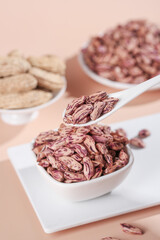 Assorted Colorful Legumes and Beans Collection in White Bowls with Wooden Spoon on Neutral Background