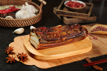 Smoked Bacon Slab on Wooden Board with Rustic Farmhouse Kitchen Spices and Traditional Cooking Setup
