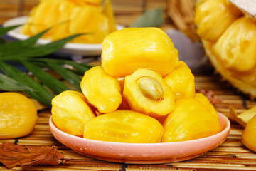 Fresh Thai Honey Pineapple Pieces on Plate with Tropical Leaves and Bamboo Mat