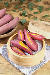 Steamed Sweet Potatoes in Bamboo Steamer - Fresh Healthy Root Vegetables on Rustic Wood Table