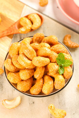 Roasted Salted Cashew Nuts in Bowl with Mint Garnish - Healthy Snack Food