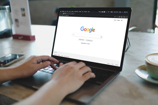 Bangkok, Thailand. September 29, 2025; A person using the Google search engine on a laptop to find information on the internet, with a cup of coffee at their desk.