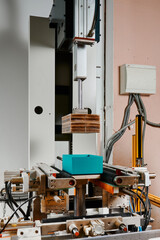 Efficient machine wrapping system in action, optimizing packaging for various rectangular boxes in a modern facility