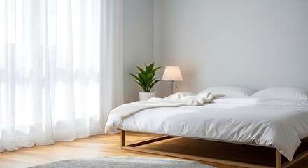 Bright and serene modern bedroom with minimalist design, comfortable white bedding, and soft natural light streaming through sheer curtains, creating a peaceful and inviting atmosphere