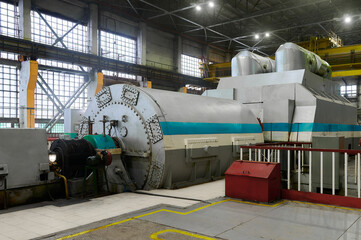 Steam turbine generator operating in a power plant during daytime in a modern industrial facility