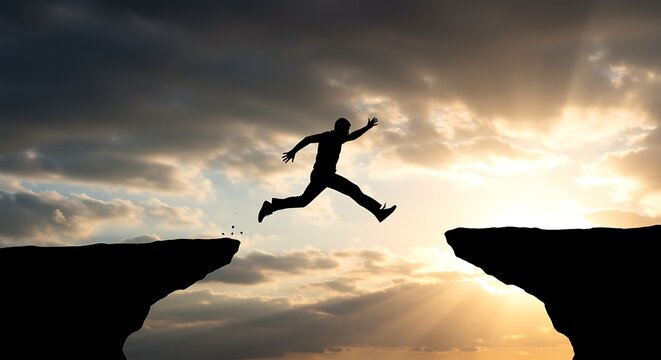 Silhouette of a person jumping over a chasm against dramatic sky