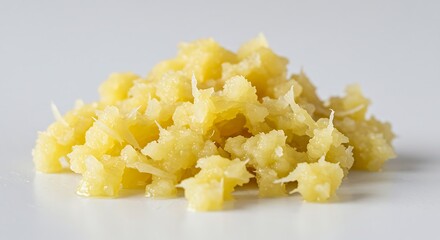 Pile of minced fresh ginger on white surface culinary ingredient