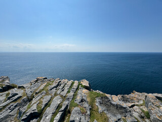 Stone ledge over dark blue ocean