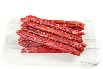 Air-Dried Spicy Red Sausages Stack - Gourmet Meat Products on White Background