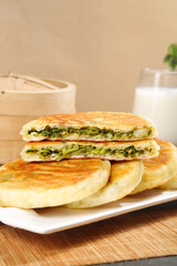 Homemade Spinach Herb Hand Pies Pastries on Plate with Milk Glass Breakfast Food