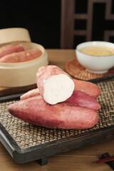 Fresh Sweet Potatoes with White Flesh on Bamboo Serving Tray