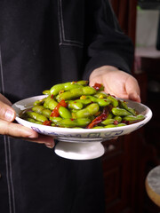 Freshly Picked Spicy Green Beans with Chili Peppers in Traditional Bowl - Asian Cuisine Yunnan Style Preparation
