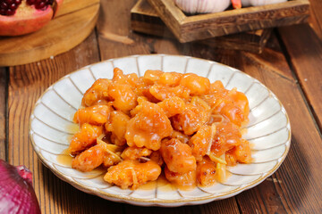 Sweet and Sour Stewed Pork in Orange Glaze on Traditional Wooden Table Setting